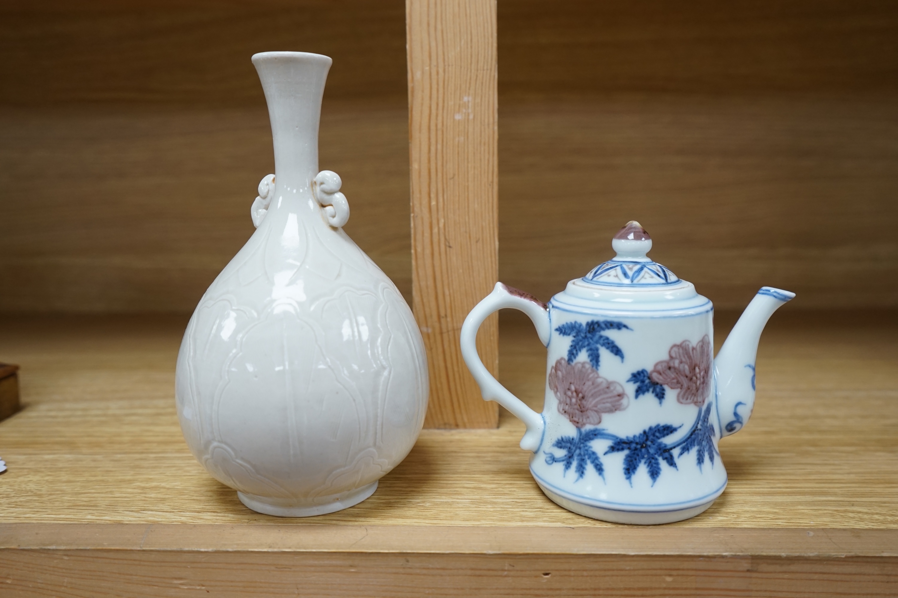 A Chinese carved bottle vase, 18cm high, and a small teapot. Condition - fair to good.